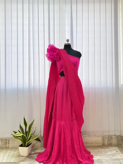 A full view of the contemporary pink half saree on a mannequin, highlighting its unique silhouette and bold design.