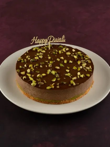 This is my Pistachio Kunafa Chocolate cake, a unique fusion dessert for Diwali. It combines the textures of crunchy kunafa and creamy chocolate pistachio mousse.
