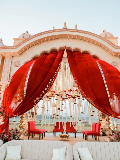 A closer look at the mandap, where red drapes and floral details create a rich, traditional, and intimate setting for the wedding ceremony.