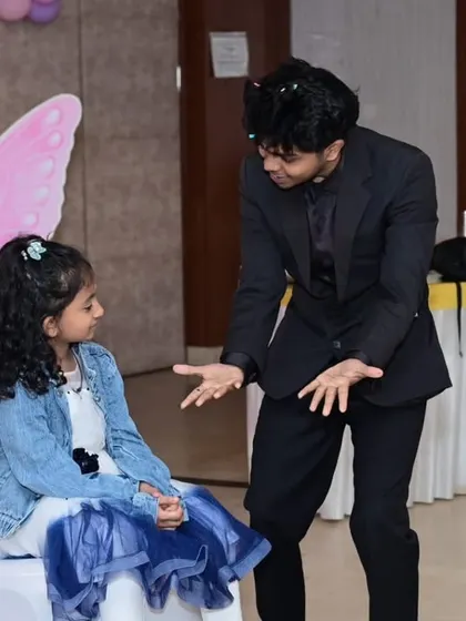 The moment of anticipation just before the magic happens. I'm explaining the trick to my volunteer, getting her and the audience ready for the surprise. This was at a lovely butterfly-themed party.