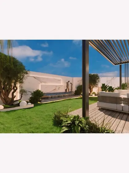 From this angle, you can see the beautiful relationship between the soft green lawn, the mature trees, and the modern hardscaping of the deck and water feature. The design creates a harmonious blend of natural and built elements.