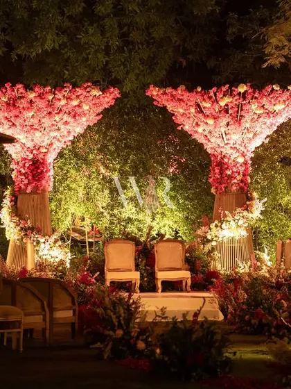 Another angle of the unique pink floral tree mandap. The four sculptural trees form a canopy over the ceremony space, creating a truly one-of-a-kind setting for a modern wedding.