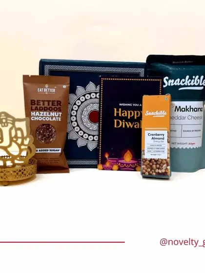 Another affordable and elegant Diwali hamper. This one features a Ganesha T-light holder, healthy snacks, and a Diwali card, perfect for bulk orders.