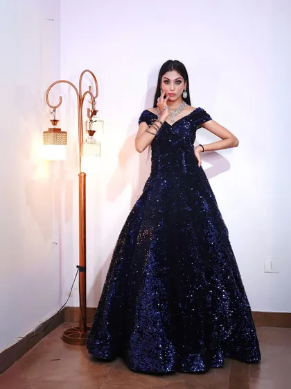 Shine like a star in this stunning blue sequin gown, available to rent for your next big event.