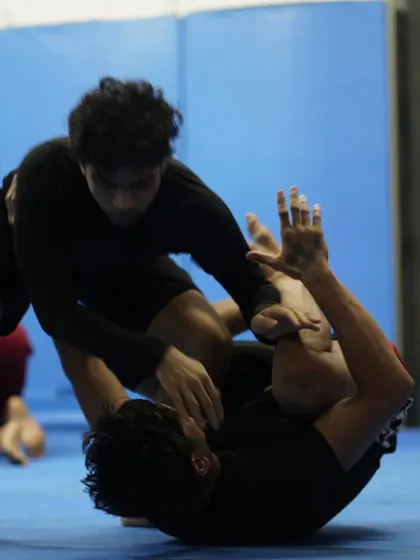 A dynamic grappling exchange where a student works to pass the guard. Guard passing is a key skill in BJJ, requiring pressure, timing, and technique.