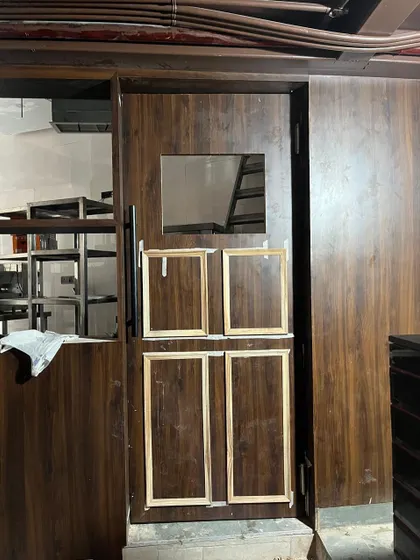 A detail shot of a door being fitted during the Melt House construction. Even seemingly small elements require careful planning and execution to fit into the overall design scheme.