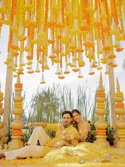 A serene moment for the couple amidst the marigold decor before the Haldi madness began in Goa.