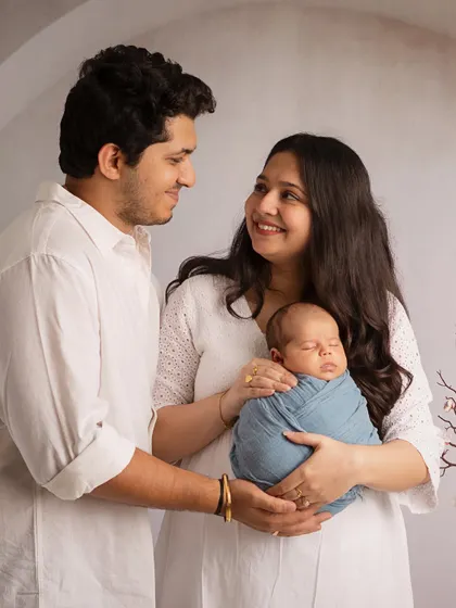 A look of love. The way these new parents look at each other while holding their baby tells a beautiful story of their journey together.
