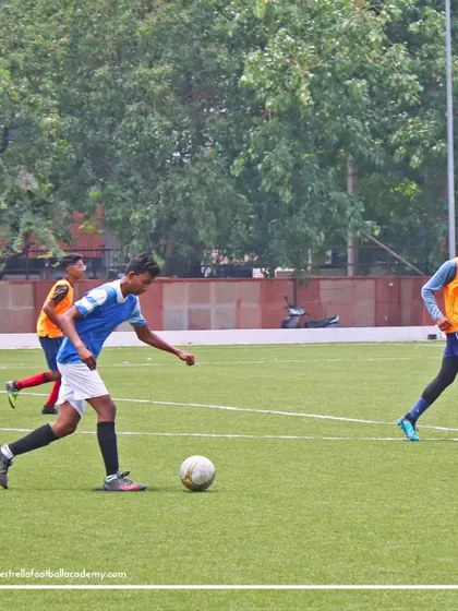 An aspiring player dribbling past defenders during a trial match. These games are a critical part of our evaluation, allowing us to see how players perform under real match pressure.