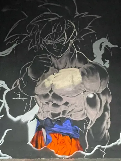 Another progress shot of the Goku mural, showing the transition from outline to a fully rendered character.