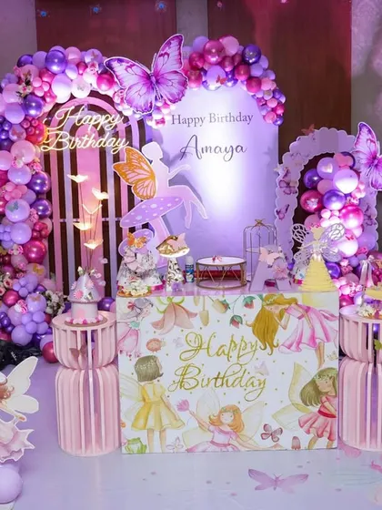 This butterfly garden theme is one of our signature designs. The setup features large, elegant butterfly wings, fairy cutouts, and a beautiful arch of purple and pink balloons, transforming any space into an enchanted forest.