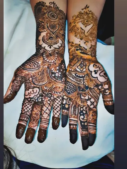 This bride wanted to include unique symbols in her mehendi. We designed each hand differently, incorporating traditional patterns with cloud and bird motifs that were special to her.
