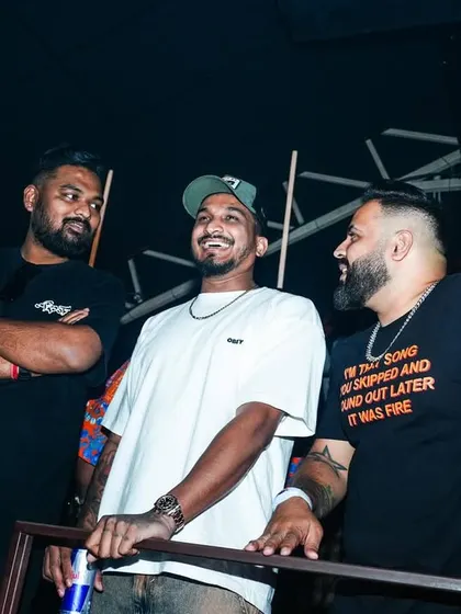A candid moment with DIVINE and another friend at an event. These are the relaxed, behind-the-scenes moments.