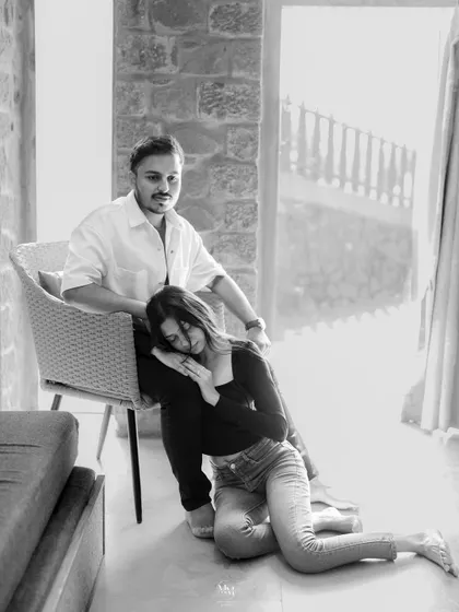 A beautifully composed black and white portrait. She rests peacefully against him, a moment of complete trust and comfort captured in a timeless style.