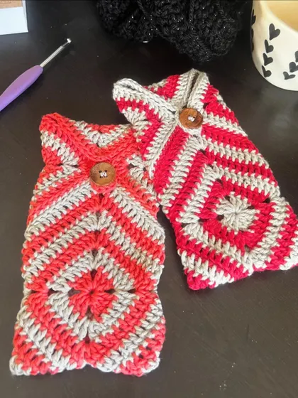A pair of finished granny square pouches, ready to be used for sunglasses, pens, or any other small items.