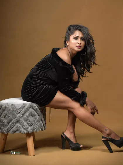 A full-body shot in a black velvet dress. This portrait showcases a confident pose and a classic party look, perfect for a model's lookbook.