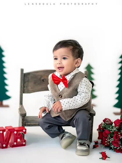 A dapper little gentleman sitting on a bench, surrounded by roses. This setup was perfect for a Valentine's or special occasion photoshoot.