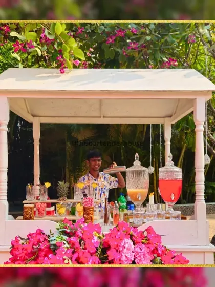 A cutesy and charming bar cart, perfect for an outdoor garden party. Adorned with beautiful bougainvillea, this setup serves refreshing juices and cocktails in a picturesque setting.