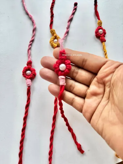 Holding one of the flower Rakhis to show its delicate size. It's a simple yet beautiful way to celebrate the bond between siblings.