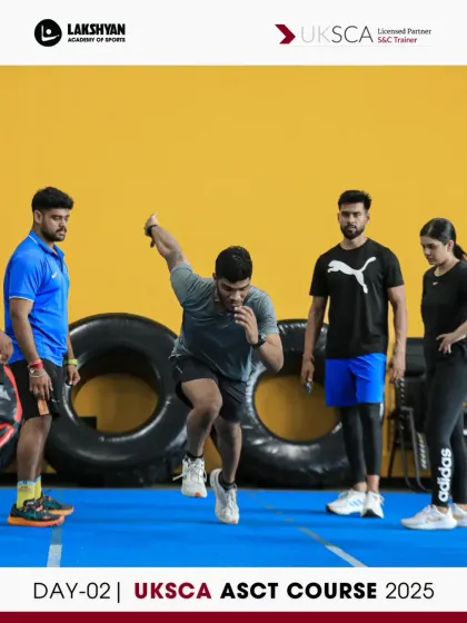 A participant practices a lateral jump during the foundational movement session on Day 2, focusing on explosive power and stability.
