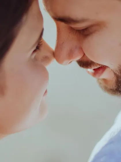 An extreme close-up capturing the tender moment just before a kiss. This shot is all about intimacy, focusing on the soft light on their faces and the palpable sense of affection.