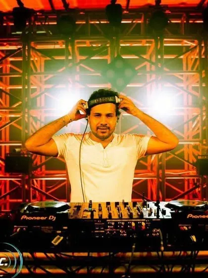 Locked in. Adjusting my headphones and getting ready for the next transition against a massive truss and lighting rig.