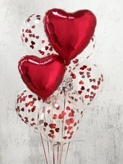 A simple yet classy bunch perfect for Valentine's Day. This arrangement mixes red heart foil balloons with clear balloons filled with tiny red heart confetti.