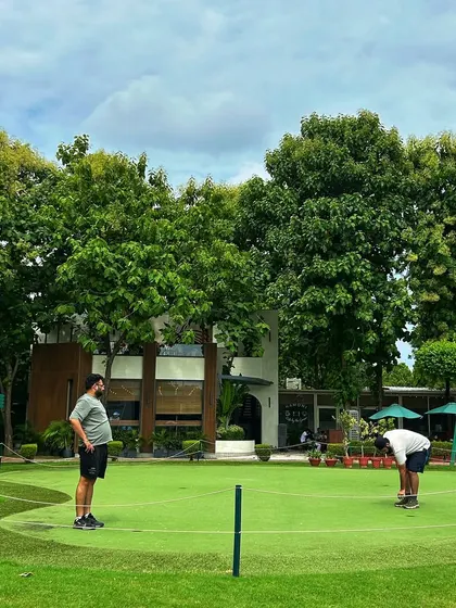 Our expansive putting green, with the Hamoni Cafe in the background, is the perfect place to work on your short game or just unwind with friends.