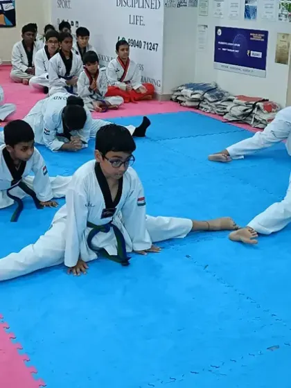 Students hold a deep stretch, showing their dedication.
