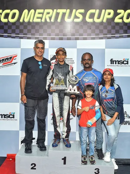 The family of a young champion celebrates on the podium at the Meco Meritus Cup 2024. We foster a community environment where families are an integral part of the racing journey.