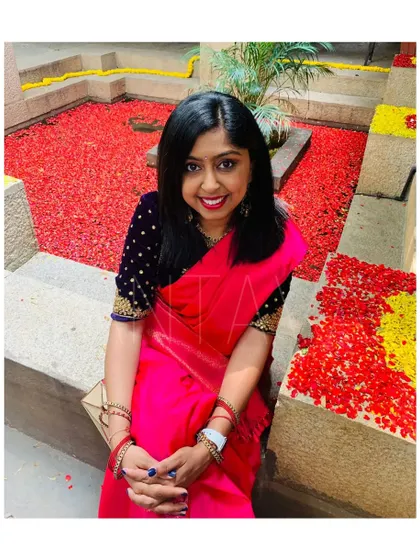 Another beautiful shot of the client in her navy velvet blouse, showcasing its rich texture and the intricate hand embroidery on the sleeves.