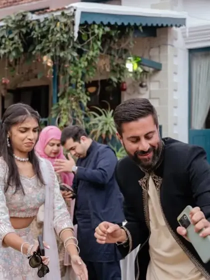 Capturing the candid moments of celebration. A couple enjoys a dance at their outdoor wedding event, surrounded by friends and family.