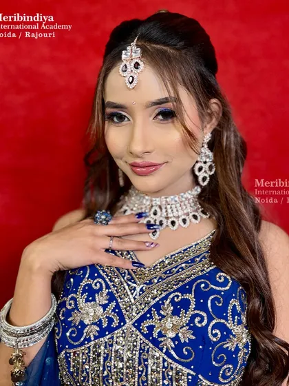 The complete engagement look, where the hair is styled with soft curls to complement the royal blue outfit.