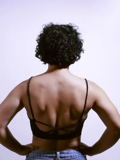 A powerful back portrait of a fitness influencer. This shot highlights the definition and strength of her back muscles, captured in my home studio.