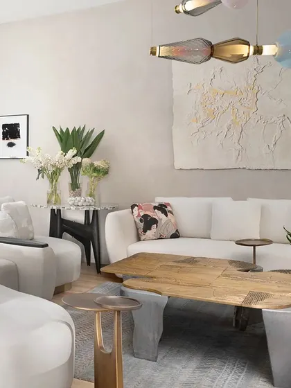 A vignette of our Koko furniture, highlighting our focus on craftsmanship and contemporary elegance. The 'Curved Couch', 'Twin Table', and 'Plateau Coffee Table' showcase our use of cast brass, recycled materials, and luxurious velvets to create unique, artistic pieces.