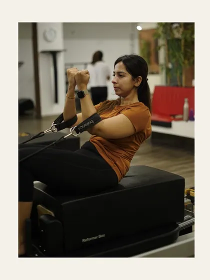 This client is deep in concentration, working her biceps and core using the short box.