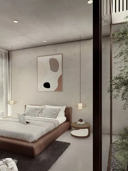 A bedroom in a Pavilion home with a private courtyard garden. The floor-to-ceiling glass wall dissolves the boundary between the sleeping area and the outdoors, creating a serene retreat.