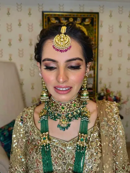 A close-up of the bride's warm, smokey eye makeup and the elegant updo peeking out from the side.