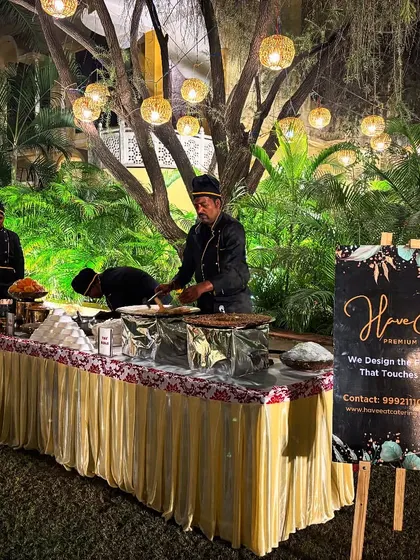 A live chaat counter set up under beautiful evening lights at a wedding, providing guests with delicious and interactive food options.
