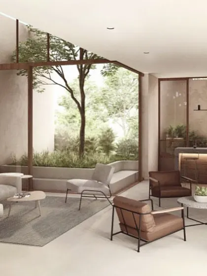 The living area of the vertical villa in The Nest. The space is organized around a double-height courtyard, with carefully selected furniture and finishes that create a luxurious yet understated tropical modern feel.