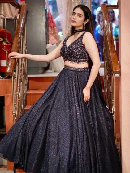 Walk into the spotlight in this shimmering navy blue lehenga. The glittery fabric and simple, modern silhouette make it an effortlessly chic choice for an evening event.
