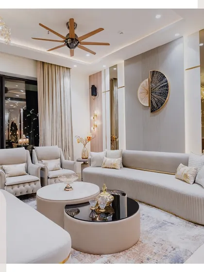 The same living room at night, showing how the lighting design creates a completely different, magical ambiance with a view of the beautifully lit balcony.