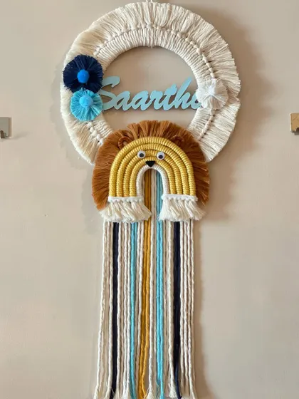 A custom name hanging for Saarthak, also with the popular lion rainbow theme. The blue and yellow color scheme gives this piece a bright and cheerful feel.
