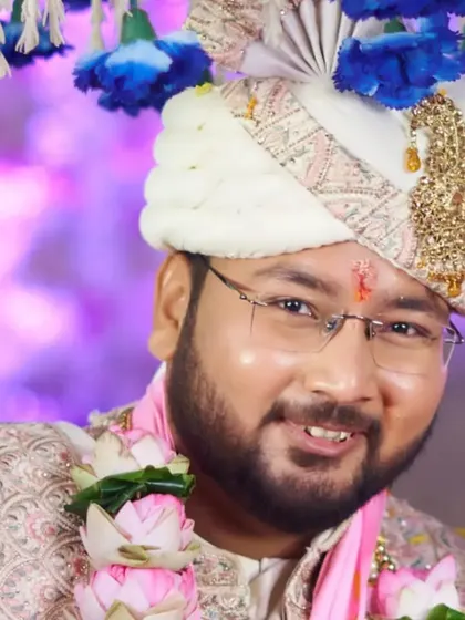 Another shot of the groom during his wedding, this time with a beautiful lotus garland. The makeup holds up perfectly, keeping him photo-ready.