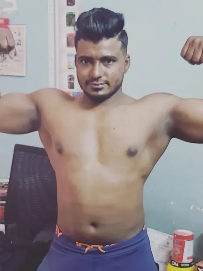 A client showing off his impressive bicep development. This is the kind of muscle gain we work towards with a consistent and personalized training plan.