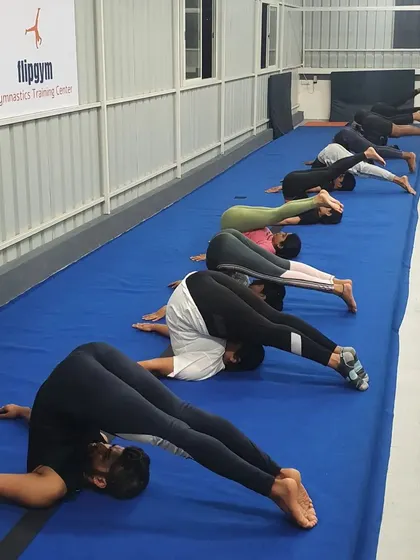 The plow pose is an excellent stretch for the spine and shoulders. Our adult members incorporate this into their cool-down routine to improve flexibility.