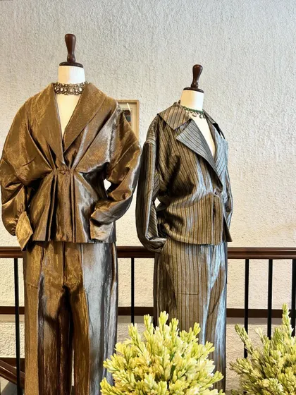 A different angle on the metallic ensembles, highlighting their unique textures and silhouettes.