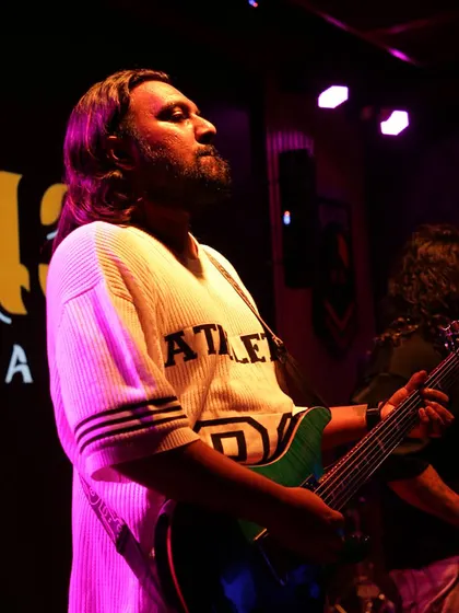 Our guitarist, crafting magic with his strings. His fire and soul shine through in every performance.