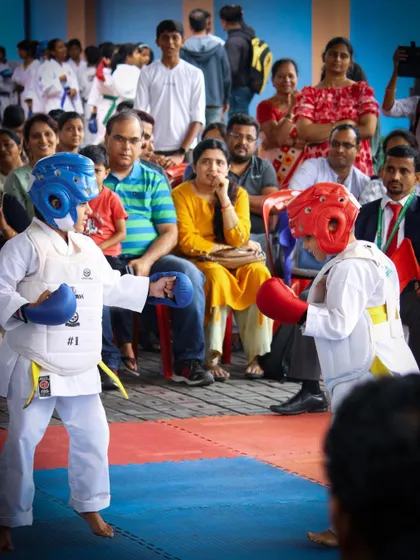 Two young boys engage in a kumite match, demonstrating the skills and courage they've developed through our competition training program.