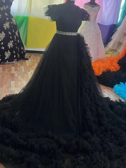 Our black ruffle gown is an elegant and dramatic choice, seen here on a mannequin in my store.